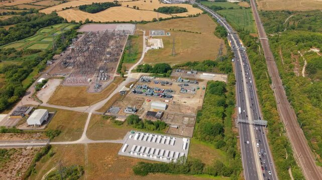 Aerial view of utility scale battery energy storage system BESS alongside the busy M1 motorway near Luton, UK