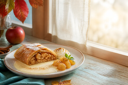 Warm Apple Strudel with Vanilla Sauce in an Autumn Caf&eacute; for Oktoberfest