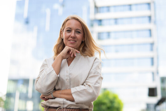 Confident business woman posing outside office building