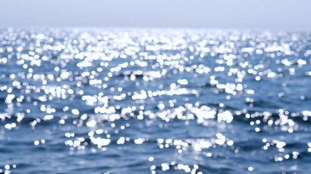 Sea. Sea waves, horizon line, blue sky. Abstract view of blue sea with white ripples on water and white sun glare on sunny summer day. Nature backdrop. Natural background. Concept summer vacation