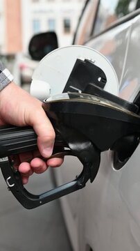 Man Filling Up Car With A Close-Up Of Hand In Vertical Video