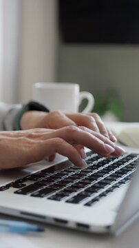 Woman Working Remotely On Laptop From Home Close-Up Of Hands Vertical Video