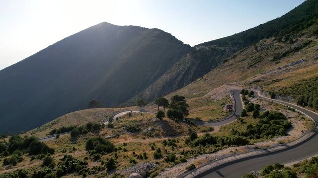 Aerial view of the winding Llogara Pass mountain road near Vlora and Zeus mountain, amazing scenery view. Aerial panoramic drone view from above, top view from drone. 
