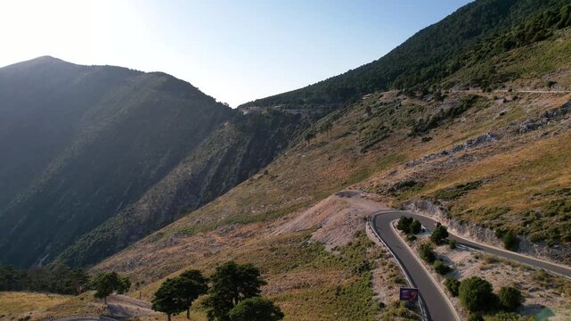 Aerial view of the winding Llogara Pass mountain road near Vlora and Zeus mountain, amazing scenery view. Aerial panoramic drone view from above, top view from drone. 

