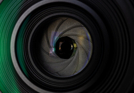 Close-up of camera lens aperture blades and glass element,Macro,Detailed close-up shot of a camera lens showing the intricate mechanical aperture blades, iris mechanism, and optical glass elements,
