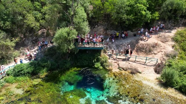 Beautiful view Blue Eye syri i kalter natural springs in Delvine Sarande Albania. Aerial rising over Blue eye spring a natural phenomenon in Albania. Aerial panoramic drone view from above, top view f