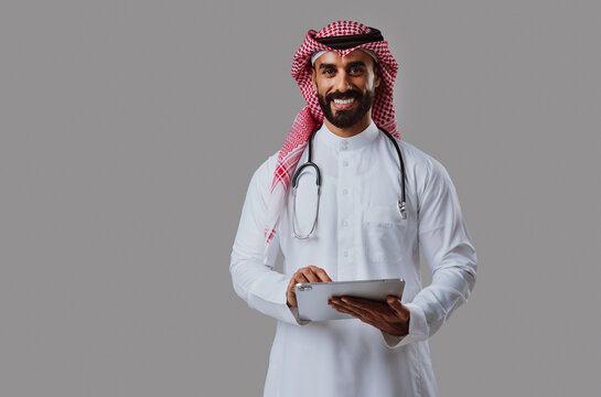 Arab male doctor holding clipboard, stethoscope on shoulders