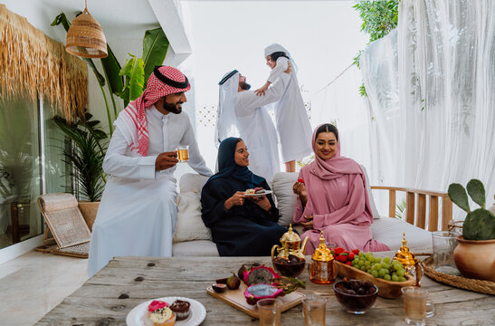 Middle eastern family in traditional attire sitting together