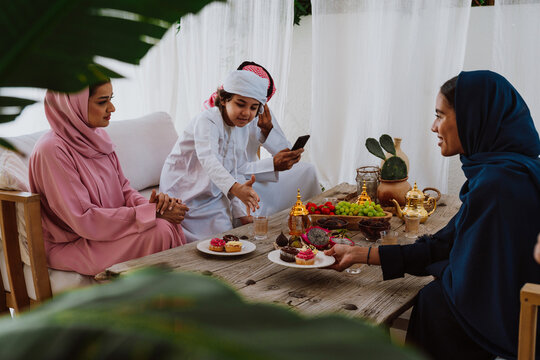 Emirati family at home. Muslim family sharing iftar at countryside home.