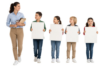 Obraz premium Teacher walking beside four children holding blank boards. Education, classroom, learning, creativity, teaching.