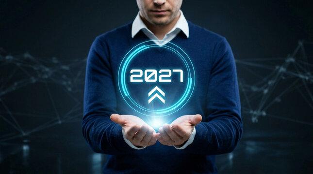 Man holding glowing holographic 2027 projection with upward arrow symbolizing future technology and innovation