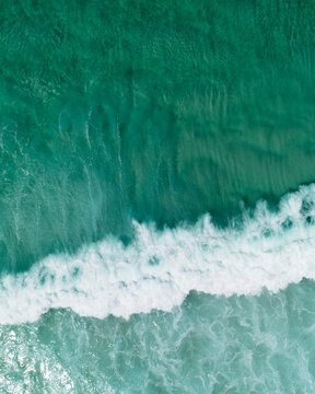 Wave breaking on a clear blue water