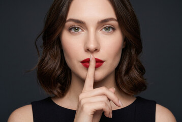 Naklejka premium Woman Making Silence Gesture With Finger on Lips