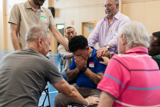 Men offering emotional support during a group session