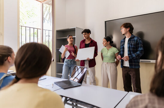 Students presenting group work in a modern classroom