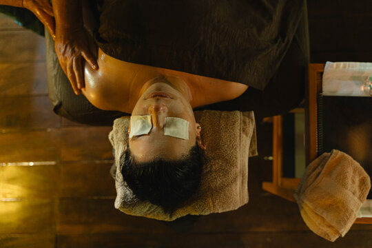 Client receiving luxurious relaxation facial during oil massage