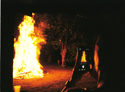 Capturing bonfire flames at night with smartphone outdoors