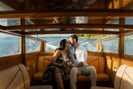 Elegant Couple Celebrating with a Toast on Private Yacht