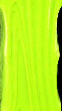 Bright green slime dripping down on a solid black background