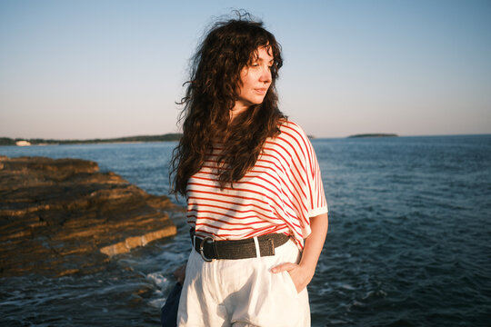 Woman in striped shirt by the sea