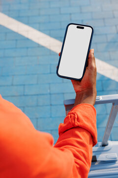 Travel smartphone mockup with white screen on blue tiles