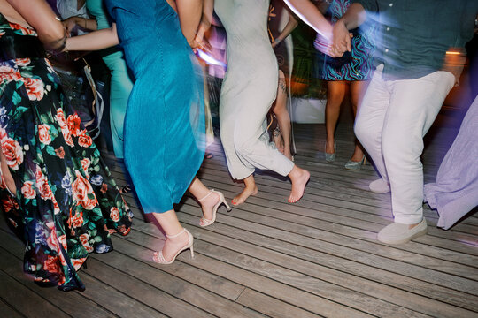 People dancing together on wooden floor at party