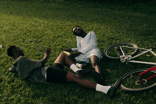 Friends Resting Beside Bicycles.