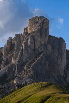 Golden sunset light on Dolomite cliffs in Passo Giau