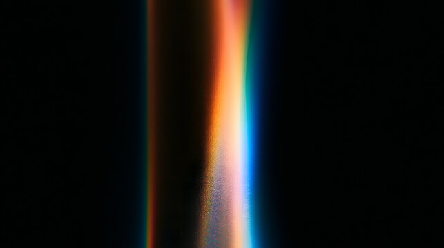 Abstract light reflection creating vibrant, colorful streaks on a dark background.