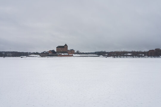 Hame Castle across lake in winter in Hameenlinna, Finland
