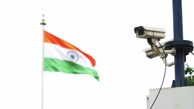 Surveillance CCTV camera beside the Indian national flag symbolising security
