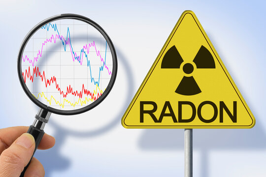 RADON GAS HAZARD CONCEPT &ndash; RADIOACTIVE WARNING SIGN WITH RADIATION SYMBOL, MAGNIFYING GLASS AND RADON LEVEL MEASUREMENT GRAPH