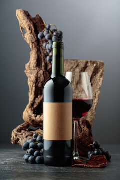 Red wine with stone, dried snags, and blue grapes.