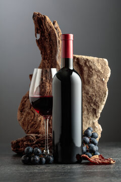 Red wine with stone, dried snags, and blue grapes.
