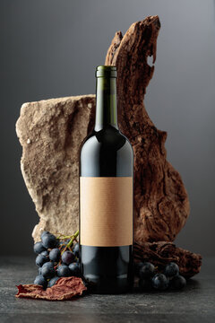 Red wine with stone, dried snags, and blue grapes.