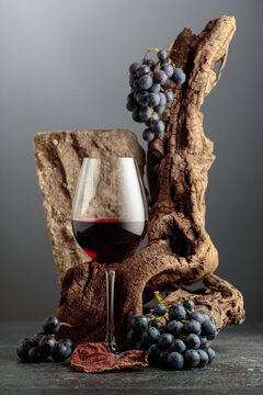 Red wine with stone, dried snags, and blue grapes.