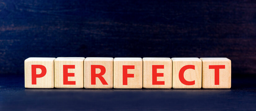 Perfect word symbol. Concept word Perfect on beautiful wooden blocks. Beautiful black table black background. Business perfect word concept. Copy space.