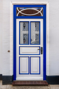 Historic white and blue front door with decorative glazing and traditional design elements