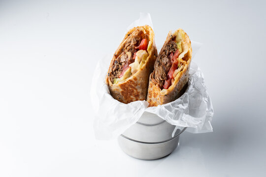 Gourmet beef shawarma wrap with fresh vegetables and creamy dressing