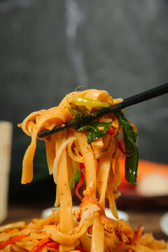 Stir-Fried Rice Noodles with Vegetables on Chopsticks - Asian Cuisine Food Photography
