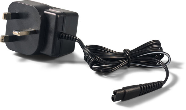 black uk power adapter plug isolated white background, three pin mains charger with coiled wire and small connector in close-up view