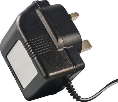 black uk power adapter plug isolated white background, plastic casing with metal pins and attached cable in close-up view