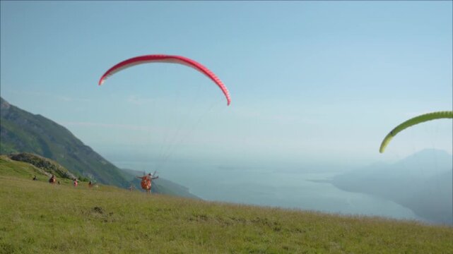Paraglider Soaring Above Majestic Mountain Peaks Under a Vast Blue Sky, Adventurous Outdoor Aerial Sport and Scenic Alpine Landscape View