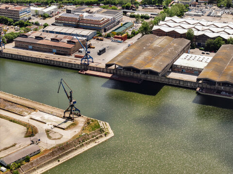 Aerial view of Mini skladista Luka Beograd featuring industrial warehouses, port cranes, and the river bank in Belgrade, Belgrade, Serbia.
