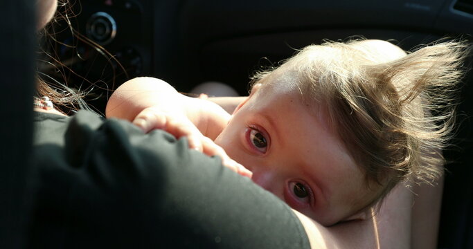 Mother breast-feeding baby toddler with funky hair