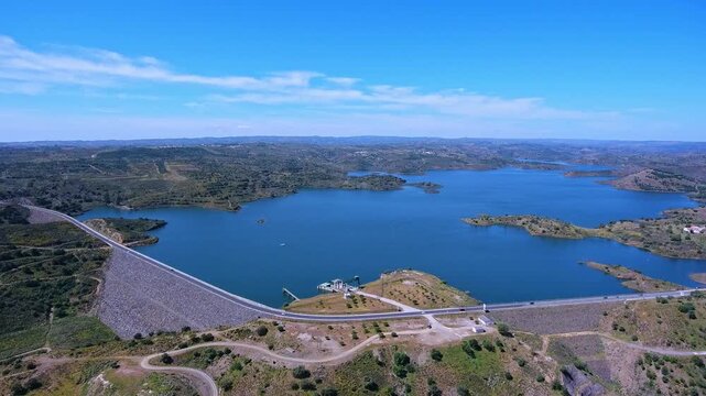 High angle view showing the odeleite dam and its extensive water reservoir in algarve, portugal, highlighting renewable hydroelectric power generation and the surrounding green landscape