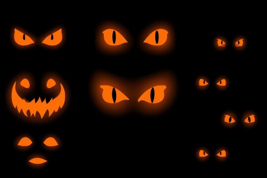 Glowing Halloween pumpkin eyes and spooky jack-o-lantern faces isolated on black background.