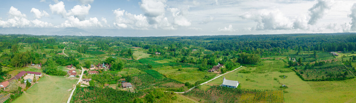 Panoramic aerial drone view of greenery grassland in Salaon Dolok, Samosir Island, Indonesia