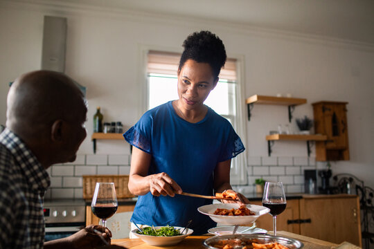 Couple enjoying homemade dinner together in kitchen