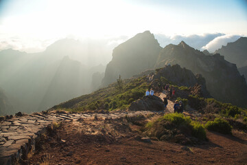 Naklejka premium Hikers walking mountain ridge trail at sunrise, Madeira